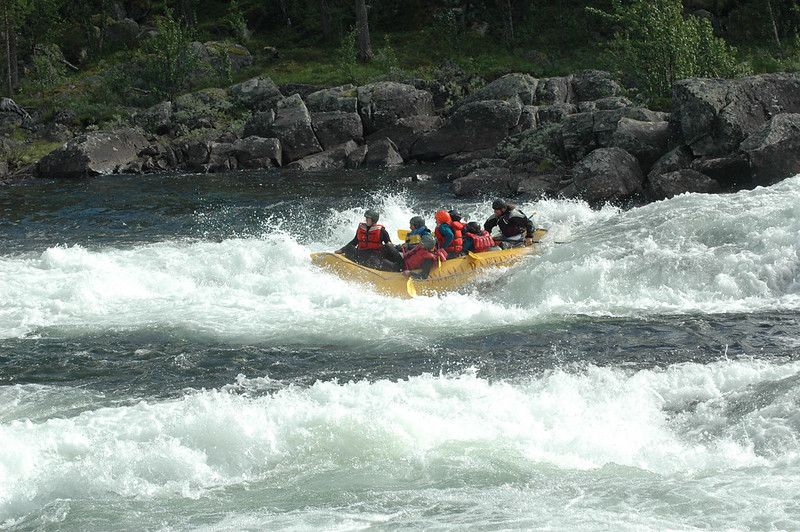 eam battling intense white-water waves during river rafting in Darjeeling.