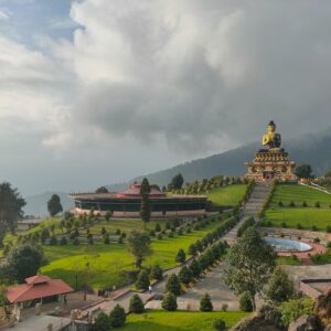 Giant Buddha statue at Buddha Park Ravangla surrounded by lush green landscape in Sikkim.